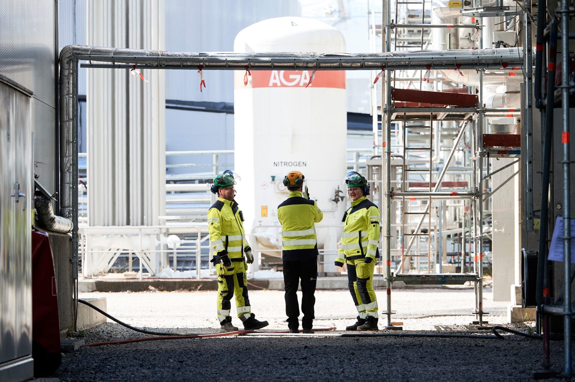 Workers in safety clothing at industrial area